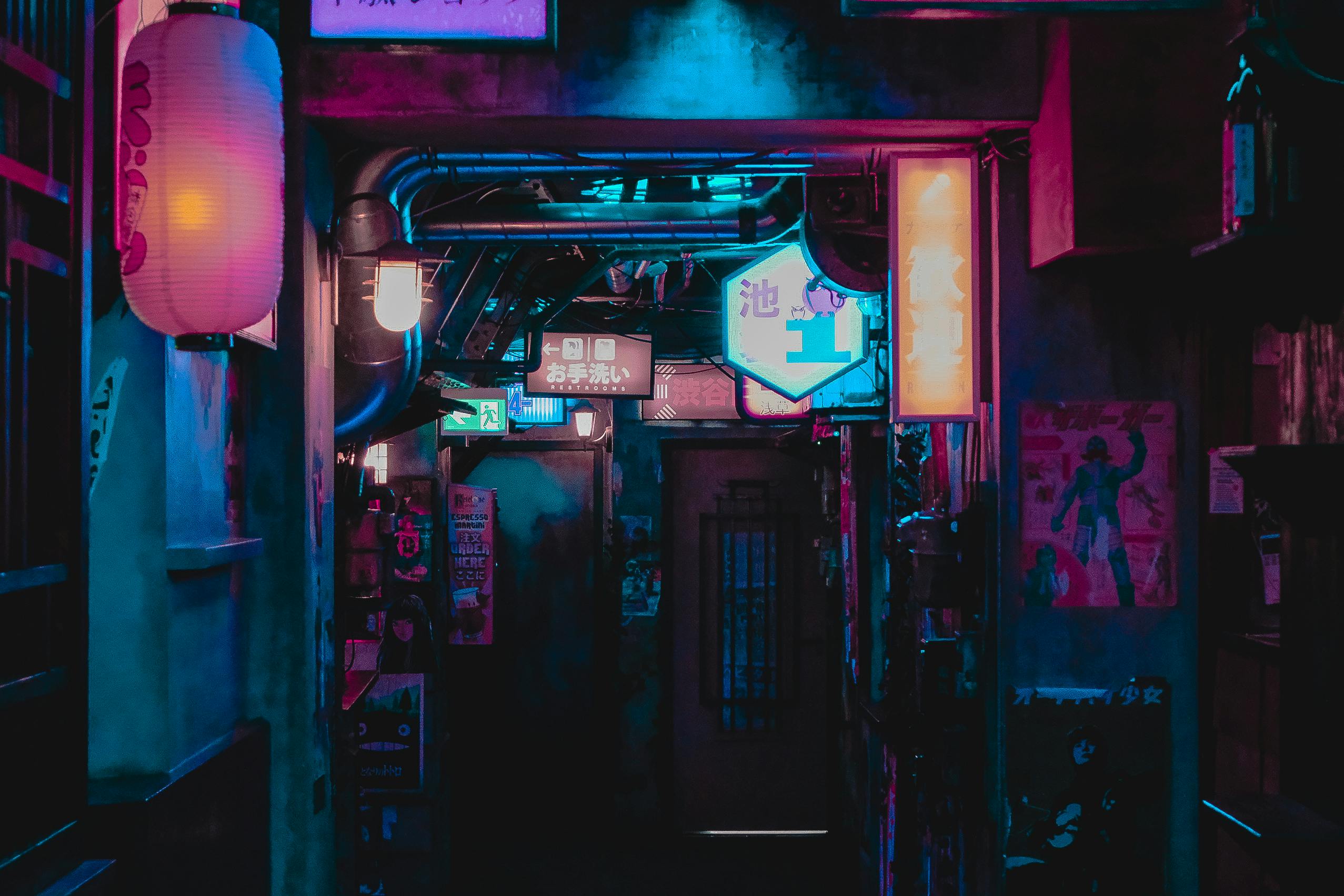 Explore a vibrant Tokyo alleyway illuminated by neon lights and signs, capturing the city's urban essence.